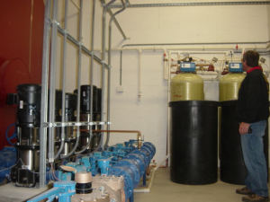 Person standing next to water storage tanks