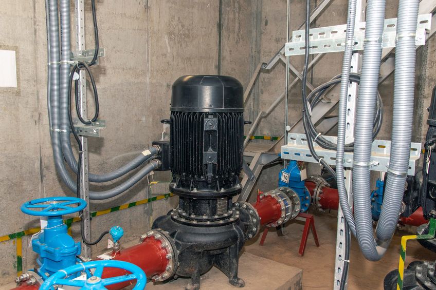 ndustrial pipeline with valves, pumps and water pressure gauges. close-up